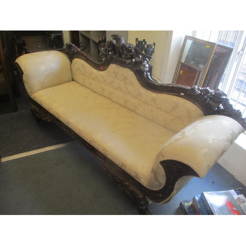 94 - A reproduction 19th century style mahogany double end sofa having a carved eagle to the centre flank... 