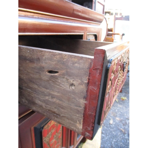 204 - A 20th century Chinese red, gold and black cabinet with two drawers and two doors on carved feet
Loc... 