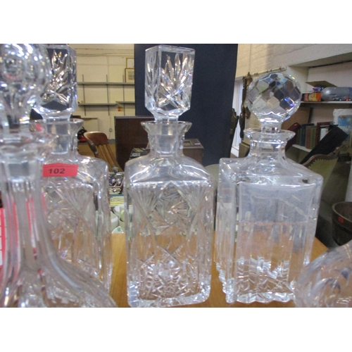 102 - Six 20th century glass decanters with stoppers and two additional stoppers