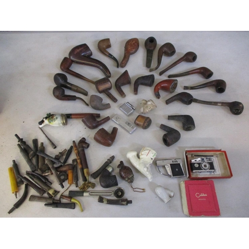 103 - A collection of smoking pipes and lighters to include cased examples