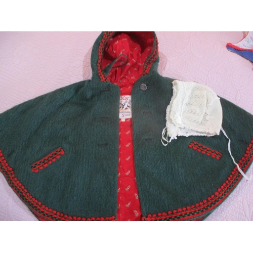 152 - A quantity of vintage children's clothing to include a Boos Austrian style green felt cape, embroide... 