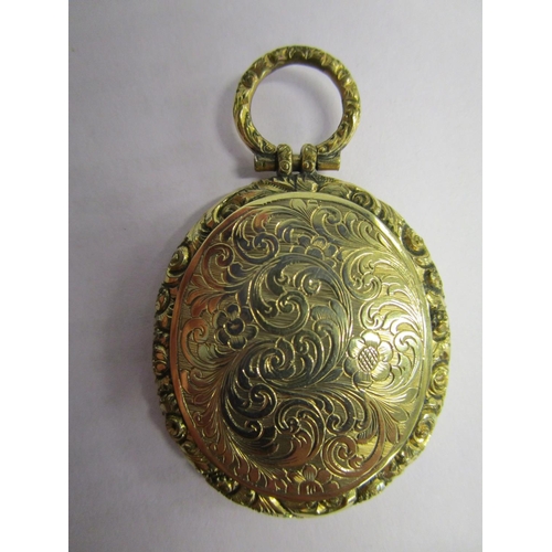 311 - A Victorian/Edwardian gold coloured pendant locket with floral engraved decoration, on a yellow meta... 