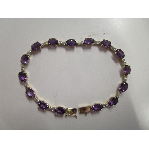 320 - 14ct yellow gold line bracelet set with oval-cut amethysts and round-cut diamonds, boxed