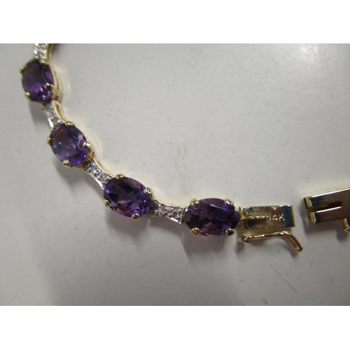 320 - 14ct yellow gold line bracelet set with oval-cut amethysts and round-cut diamonds, boxed