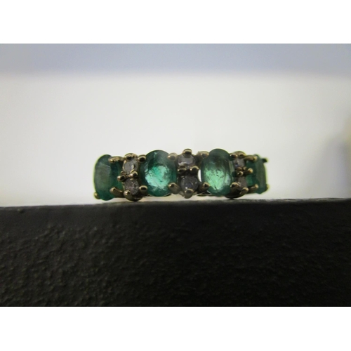 330 - 9ct yellow gold ring set with oval-cut emeralds and round-cut diamonds, boxed