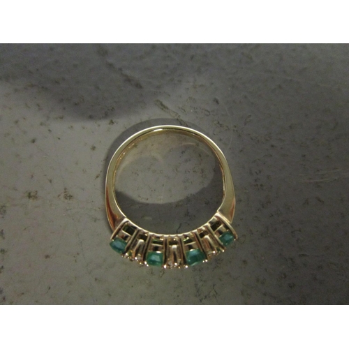 330 - 9ct yellow gold ring set with oval-cut emeralds and round-cut diamonds, boxed