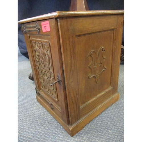 87 - An Arts & Crafts carved oak smokers cabinet depicting peacocks A/F