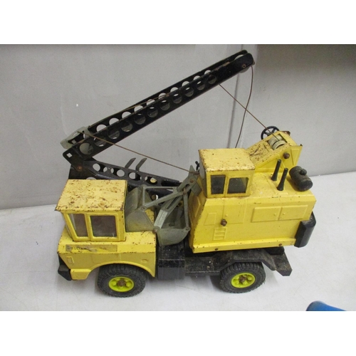 61 - A Tonka die cast excavator truck, yellow colour, together with a Donald Duck decorative model, pushi... 