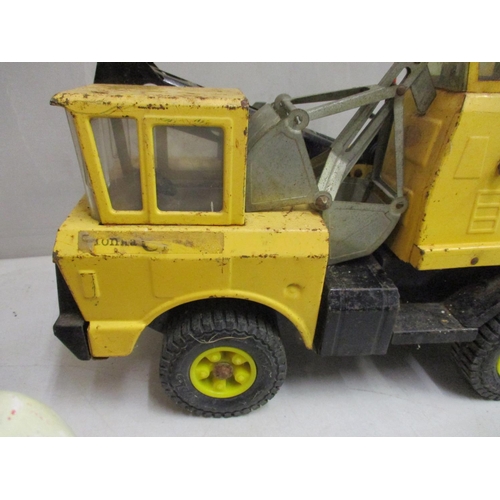 61 - A Tonka die cast excavator truck, yellow colour, together with a Donald Duck decorative model, pushi... 