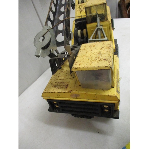 61 - A Tonka die cast excavator truck, yellow colour, together with a Donald Duck decorative model, pushi... 