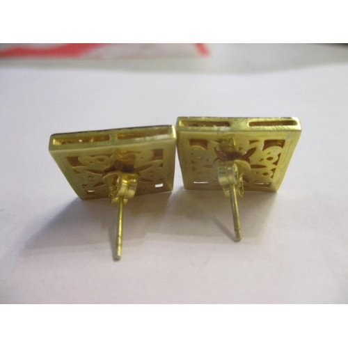 80 - A pair of silver gilt earrings of square form set with diamonds