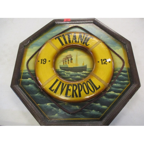 367 - A reproduction wooden plaque depicting the Titanic 1912 at sea with a raised image of a lifeguard ri... 