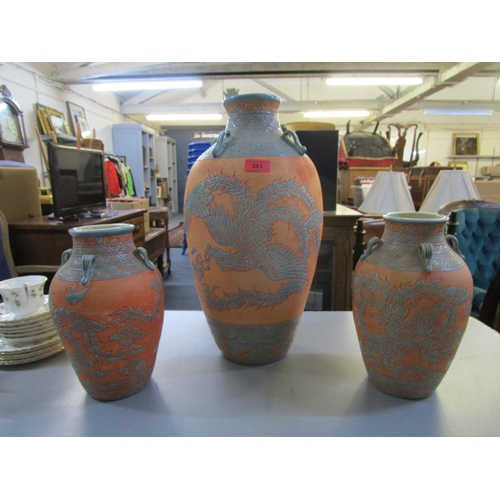 381 - An Asian pottery vase decorated with a Phoenix in flight, along with a pair of smaller matching vase... 