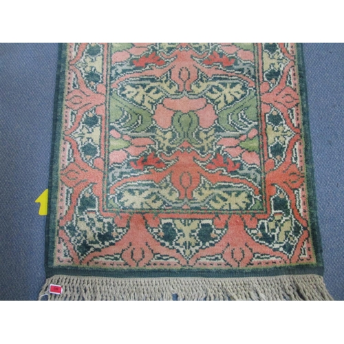 383 - A hand woven terracotta ground runner with tasselled ends 298 x 91cm