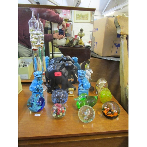 386 - A mixed lot to include glass paperweights, along with a Whitefriars blue controlled bubble weight, a... 