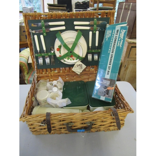 125 - A Brexton wicker picnic basket with fitted interior, and a boxed nine piece combination spanner set,... 