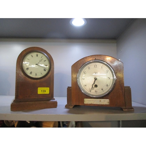 139 - An Edwardian inlaid mahogany mantle clock on plinth base, housing a French movement, and a Newport w... 