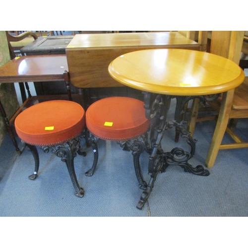 160 - A pub style circular table above ornate wrought iron stand and two similar style stools