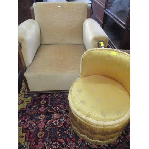 174 - A mid 20th century armchair with a gold coloured fabric and oak supports together with a gold colour... 