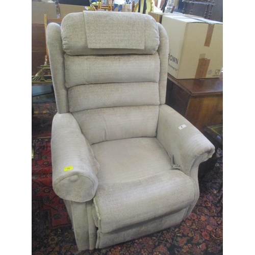 71 - A beige upholstered electric reclining armchair