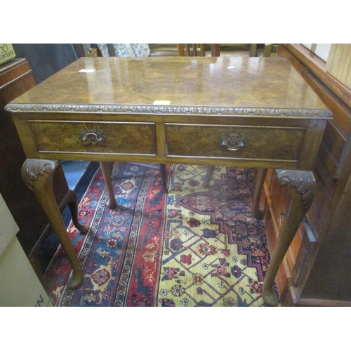 75 - A mid 20th century burr walnut veneered side table having two inset drawers and standing on pad shap... 