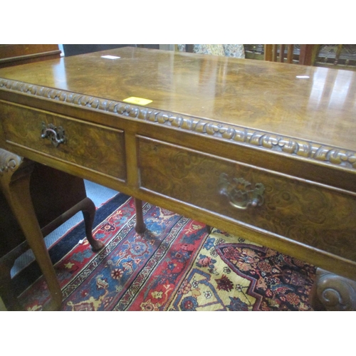 75 - A mid 20th century burr walnut veneered side table having two inset drawers and standing on pad shap... 