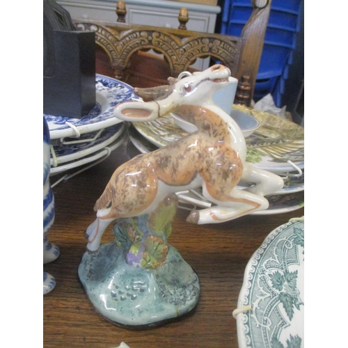 82 - A mixed lot to include a silver-plated card tray, a Basil Matthews model of a deer, a pot lid, two f... 