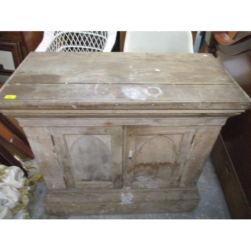 285 - A pitch pine two door side cabinet, arched fielded doors on plinth base