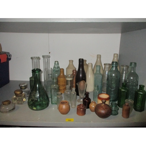 293 - A collection of glass bottles, chemical measures, inkwells and stoneware bottles and pots