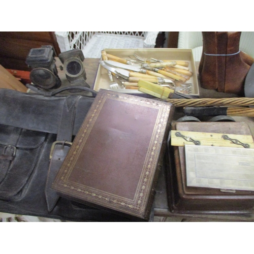 294 - A mixed lot of items to include bicycle lamps, leather cased folding camera, mixed cutlery, a pair o... 