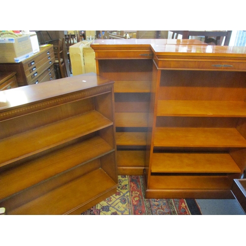 307 - A pair of reproduction yew bookcases with three adjustable shelves