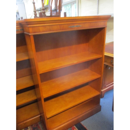 307 - A pair of reproduction yew bookcases with three adjustable shelves