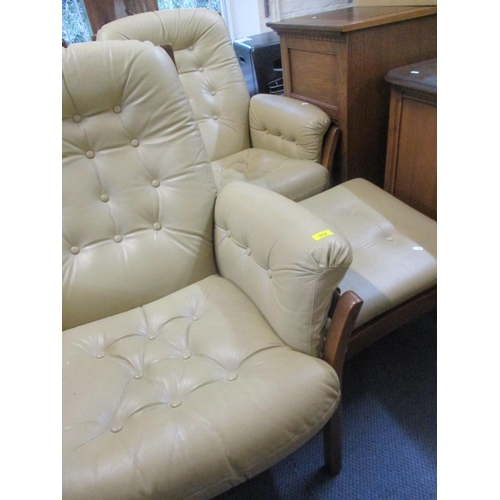 312 - A pair of Retro Ercol cream leather armchairs and one matching footstool