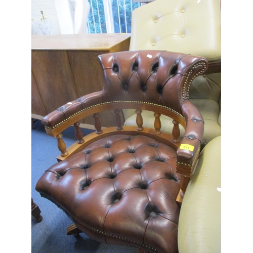 314 - A reproduction yew swivel desk chair with brown leather upholstery