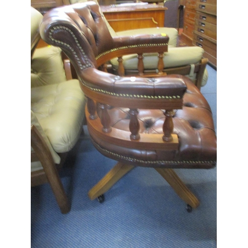 314 - A reproduction yew swivel desk chair with brown leather upholstery