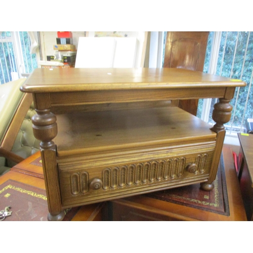 317 - An Ercol corner table with hinged rear flap and central drawer