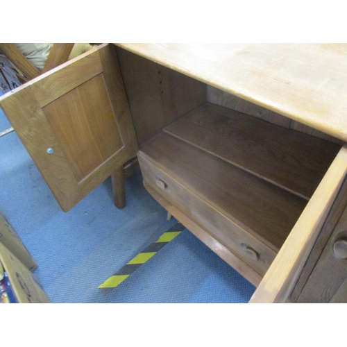 318 - An Ercol sideboard on splayed legs