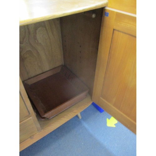 318 - An Ercol sideboard on splayed legs