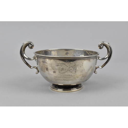 15 - A George V silver twin handled pedestal bowl by David Munsey, London 1911, with scrolled handles eit... 