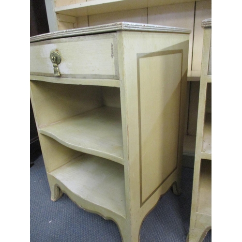 102 - A pair of cream painted Continental pine bedside chests with single drawer and shelves, in cream wit... 