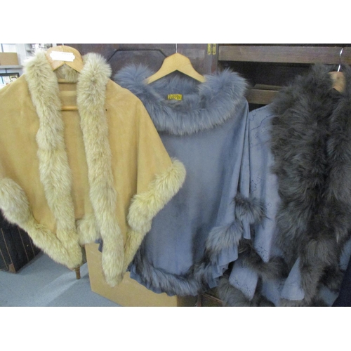 203 - Modern ladies outer garments with faux fur and rabbit fur trims to include a Jayley poncho, one size... 