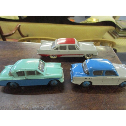 210 - Nine vintage Dinky cars to include a 471 Austin Nestle van, 180 Packard Clipper Sedan, Hudson Sedan,... 