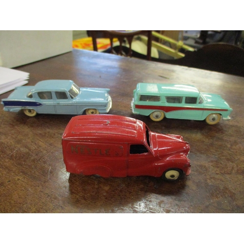 210 - Nine vintage Dinky cars to include a 471 Austin Nestle van, 180 Packard Clipper Sedan, Hudson Sedan,... 