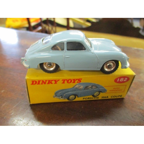 214 - Three vintage Dinky cars with original boxes to include a 189 Triumph Herald, 187 Volkswagen Karmann... 