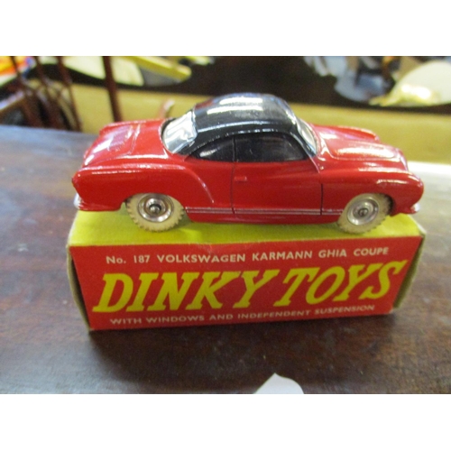 214 - Three vintage Dinky cars with original boxes to include a 189 Triumph Herald, 187 Volkswagen Karmann... 