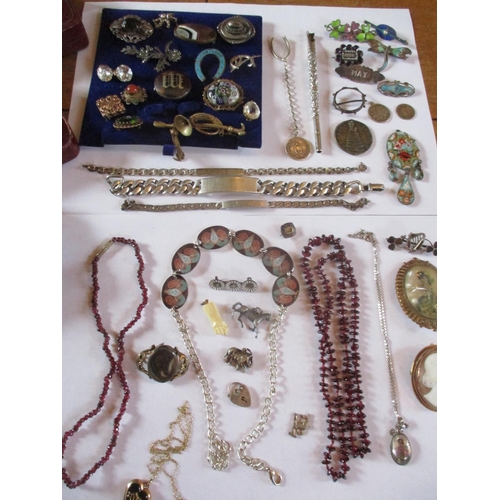 225 - Costume jewellery to include a 19th century mourning brooch, three white metal identity bracelets, f... 