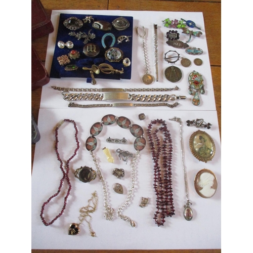 225 - Costume jewellery to include a 19th century mourning brooch, three white metal identity bracelets, f... 