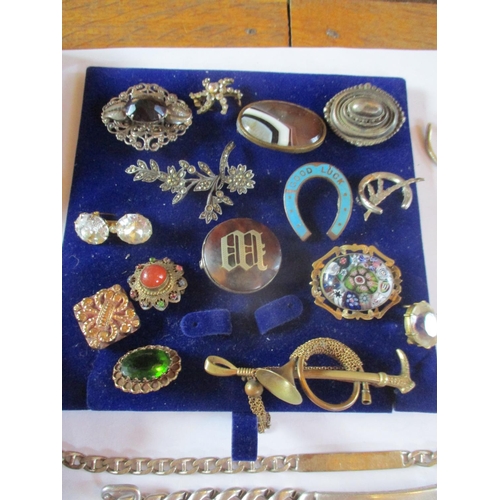 225 - Costume jewellery to include a 19th century mourning brooch, three white metal identity bracelets, f... 