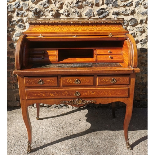 127 - A 19th century French Louis XV style tulipwood marquetry cylinder bureau, with marble top framed wit... 