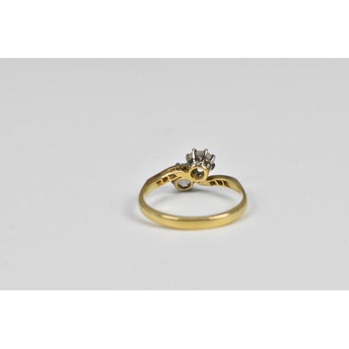 147 - An 18ct gold and diamond toi et moi ring, the two entwined round cut diamonds flanked with four diam... 